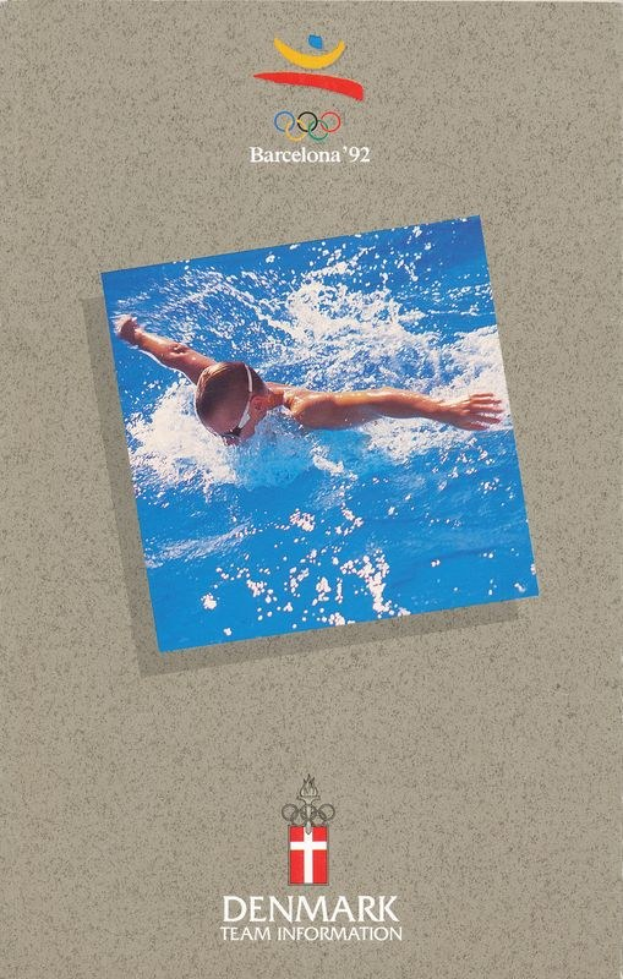Ein Plakat mit einem Schwimmer in einem blauen Anzug mit ausgestreckten Armen vor einem hellblauen Himmel mit weißen Wolken, das die Olympischen Spiele 1992 in Barcelona, Dänemark, bewirbt.