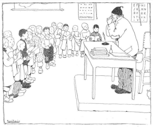 Ein Mann sitzt an einem Schreibtisch mit Büchern und Gegenständen vor einer Gruppe von Kindern, mit Papieren an der Wand dahinter, trägt Schuhe.